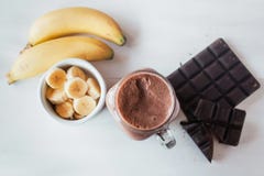 Banana and chocolate smoothie in the glass jar milkshakes, natural and organic drink royalty free stock photography Banana and chocolate smoothie in the glass jar milkshakes, natural and organic drink royalty free stock photography