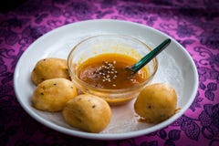 Banana with powder deep fried with syrup sesame sauce in a bowl stock images Banana with powder deep fried with syrup sesame sauce in a bowl stock images