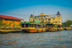 BANGKOK, THAILAND - FEBRUARY 09, 2018: Outdoor view of a rusted and old boat at riverside at yai canal or Khlong Bang Royalty Free Stock Image BANGKOK, THAILAND - FEBRUARY 09, 2018: Outdoor view of a rusted and old boat at riverside at yai canal or Khlong Bang Royalty Free Stock Image