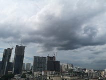 Bangkok, Thailand-June 10,2019; Black rain clouds floating in the sky environment house and building city stock photo Bangkok, Thailand-June 10,2019; Black rain clouds floating in the sky environment house and building city stock photo