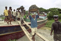 Bangladeshi workers unload freighter with cargo sand stock photo Bangladeshi workers unload freighter with cargo sand stock photo
