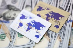 Banking cards lying on pile of US currency stock photo Banking cards lying on pile of US currency stock photo