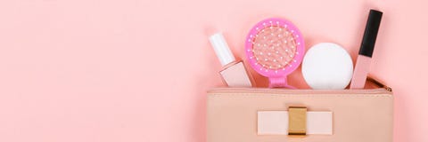 Beauty set with decorative cosmetics. nail polish, brushes and bag on pink background top view mockup stock photo Beauty set with decorative cosmetics. nail polish, brushes and bag on pink background top view mockup stock photo