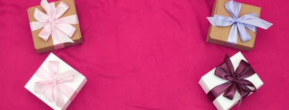 Banner four gift boxes tied with satin coloured ribbon on a pink background a Red heart. stock image Banner four gift boxes tied with satin coloured ribbon on a pink background a Red heart. stock image
