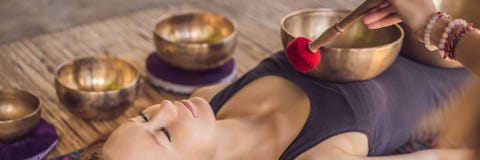 BANNER, LONG FORMAT Nepal Buddha Copper Singing Bowl At Spa Salon. Young Beautiful Woman Doing Massage Therapy Singing Stock Photo BANNER, LONG FORMAT Nepal Buddha Copper Singing Bowl At Spa Salon. Young Beautiful Woman Doing Massage Therapy Singing Stock Photo