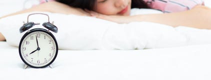 Banner website closeup alarm clock and beautiful asian young woman in morning, wake up for sleep with alarm clock, relax and stock photo Banner website closeup alarm clock and beautiful asian young woman in morning, wake up for sleep with alarm clock, relax and stock photo