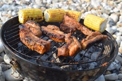 Barbecue chicken cooking on the beach with sweet corn royalty free stock photography Barbecue chicken cooking on the beach with sweet corn royalty free stock photography