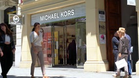 Barcelona, Spain. June 2019: People walking in front of Michael Kors store stock video Barcelona, Spain. June 2019: People walking in front of Michael Kors store stock video