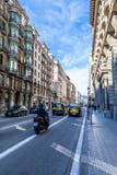 Taxi Cabs, private cars and a motorcyclist on a sunny day in the streets of Barcelona and pedestrians walking on the road. royalty free stock photos Taxi Cabs, private cars and a motorcyclist on a sunny day in the streets of Barcelona and pedestrians walking on the road. royalty free stock photos