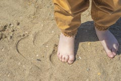 Bare children`s feet on the beach. close-up stock images Bare children`s feet on the beach. close-up stock images