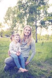 Barnet fostrar, och hennes lilla dotter tycker om liv parkerar in royaltyfria foton Barnet fostrar, och hennes lilla dotter tycker om liv parkerar in royaltyfria foton
