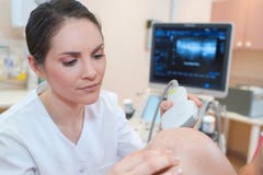 Barnet manipulerar undersökande äldre patientbråck på echograph Arkivfoto Barnet manipulerar undersökande äldre patientbråck på echograph Arkivfoto