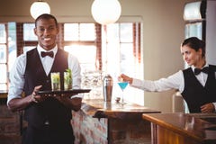 Bartender holding a serving tray with two cocktail glass royalty free stock image Bartender holding a serving tray with two cocktail glass royalty free stock image