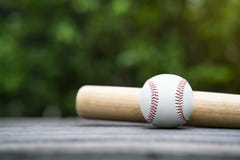 Baseball and baseball bat on wooden table background Stock Photos Baseball and baseball bat on wooden table background Stock Photos