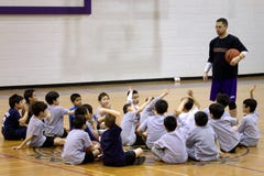 Basketball Coach with Students in the Gym