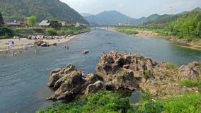 Bathing in the river in Mino in Japan. Relaxing on a hot summerday in cool water of Nagara river stock photos Bathing in the river in Mino in Japan. Relaxing on a hot summerday in cool water of Nagara river stock photos