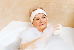 Bathing woman relaxing with sponge stock photos Bathing woman relaxing with sponge stock photos