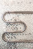 Bathroom interior in art deco style. Chrome towel warmer on a background of mirror mosaic ceramic tiles stock photos Bathroom interior in art deco style. Chrome towel warmer on a background of mirror mosaic ceramic tiles stock photos