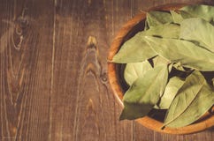 Bay Leaf In A Wooden Bowl/bay Leaf In A Wooden Bowl On A Wooden Stock Photos
