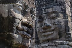 Bayon замечательно для 216 спокойного и усмехаясь каменных сторон на много башен выступающих вне от высоких террасы и группы стоковые изображения Bayon замечательно для 216 спокойного и усмехаясь каменных сторон на много башен выступающих вне от высоких террасы и группы стоковые изображения