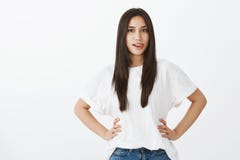 Be on bright side and smile. Portrait of joyful attractive european female with tanned skin, holding hands on hips stock image Be on bright side and smile. Portrait of joyful attractive european female with tanned skin, holding hands on hips stock image