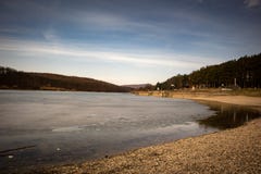 Beach by the frozen lake. Beautiful sunny winter day. royalty free stock image Beach by the frozen lake. Beautiful sunny winter day. royalty free stock image