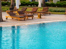 Beach lounger, sun lounger near the pool with turquoise water stock images Beach lounger, sun lounger near the pool with turquoise water stock images