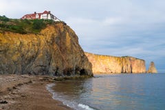 Beach and mansion on the cliff, pierced rock of Perce Stock Photography Beach and mansion on the cliff, pierced rock of Perce Stock Photography