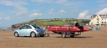 Beach scene with a car and dinghy trailer August 2018 stock photo Beach scene with a car and dinghy trailer August 2018 stock photo