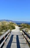 Beach with wooden boardwalk, vegetation in sand dunes and mountain. Blue sea, clear sky, Galicia, Spain. royalty free stock image Beach with wooden boardwalk, vegetation in sand dunes and mountain. Blue sea, clear sky, Galicia, Spain. royalty free stock image