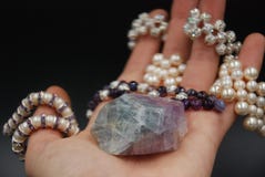 Beaded jewellery of pearls and crystals on the hand stock images Beaded jewellery of pearls and crystals on the hand stock images