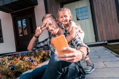 Beaming cute daughter posing for photo with her handsome father stock image Beaming cute daughter posing for photo with her handsome father stock image