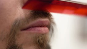 A bearded hipster combs a mustache with a comb royalty free stock photography A bearded hipster combs a mustache with a comb royalty free stock photography