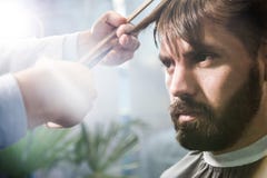 Bearded man having his hair cut stock photography Bearded man having his hair cut stock photography