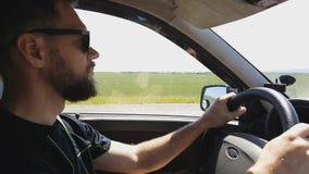 Bearded man in sunglasses driving , travel by car. stock video footage Bearded man in sunglasses driving , travel by car. stock video footage