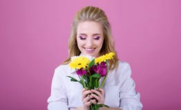 Beatiful girl with a beatiful flowers on a pink background royalty free stock photos Beatiful girl with a beatiful flowers on a pink background royalty free stock photos
