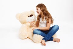 Beatiful girl sitting on floor with toy bear, telling story. stock photos Beatiful girl sitting on floor with toy bear, telling story. stock photos