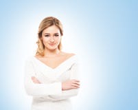Beau blond dans les tricots blancs sur le fond bleu Image libre de droits Beau blond dans les tricots blancs sur le fond bleu Image libre de droits
