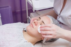 Beautician washes woman`s face using cotton pads royalty free stock images Beautician washes woman`s face using cotton pads royalty free stock images