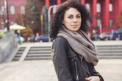 Beautifil brunette caucasian woman in leather jacket and scarf w stock photography Beautifil brunette caucasian woman in leather jacket and scarf w stock photography