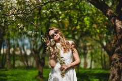 Beautiful And Fashionable Young Blonde Woman In White Dress Posing Outdoors In Park Royalty Free Stock Images
