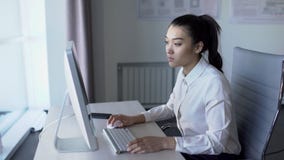 Beautiful Asian female person working in front of monitor in office. stock video Beautiful Asian female person working in front of monitor in office. stock video