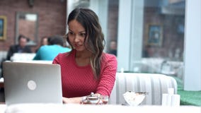 Beautiful asian woman dreaming about something while sitting with portable net-book in modern cafe bar stock photos Beautiful asian woman dreaming about something while sitting with portable net-book in modern cafe bar stock photos