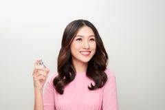 Beautiful asian woman holding a perfume bottle and applying it stock image Beautiful asian woman holding a perfume bottle and applying it stock image