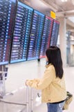 Beautiful Asian Woman Travele Standing At Flight Information Board In Airport Royalty Free Stock Photo