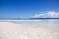 Beautiful beach in kalimantan with low tide and four berthed boa