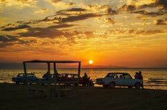 Beautiful blazing sunset landscape at Caspian sea and orange sky above it with awesome sun golden reflection on calm waves as a ba stock image Beautiful blazing sunset landscape at Caspian sea and orange sky above it with awesome sun golden reflection on calm waves as a ba stock image