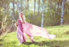 Beautiful blonde girl in a pink dress stock photo Beautiful blonde girl in a pink dress stock photo