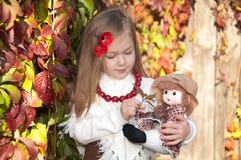 Beautiful blonde little girl with doll stock photo Beautiful blonde little girl with doll stock photo