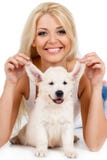 Beautiful blonde with a small white puppy of Labrador royalty free stock images Beautiful blonde with a small white puppy of Labrador royalty free stock images